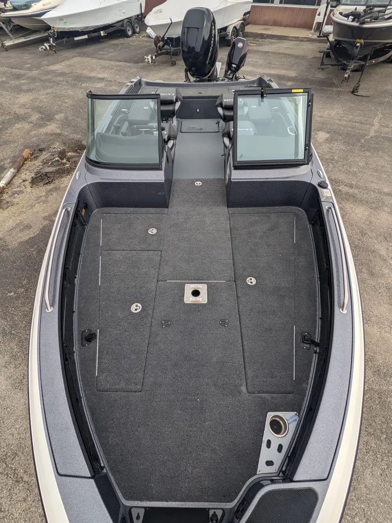 Slide: The Image of 2025 Lund 219 Pro V Fiberglass boat with open deck and windshield. - 13