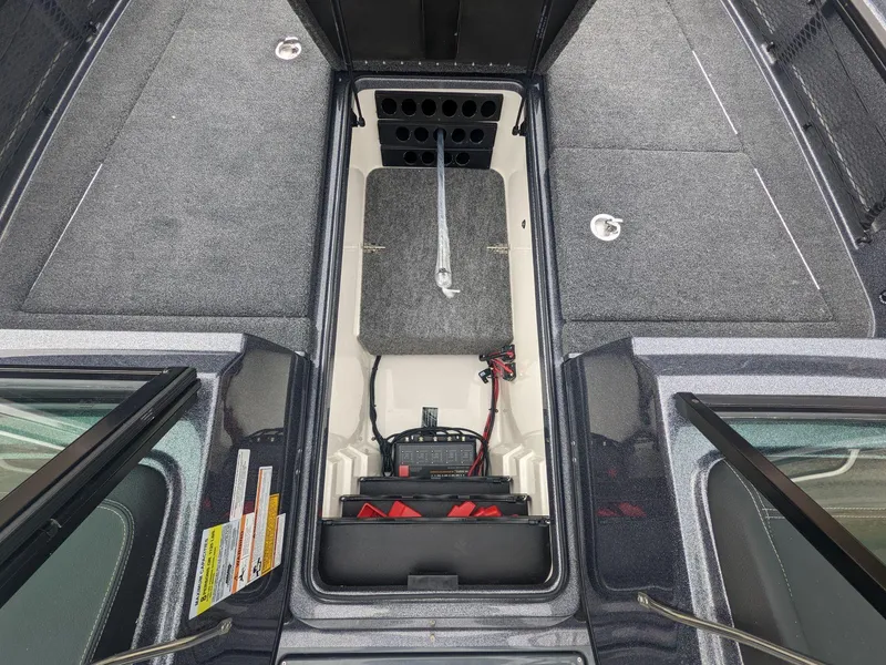 Slide: The Image of 2025 Lund 219 Pro V Fiberglass boat interior with storage compartments. - 9