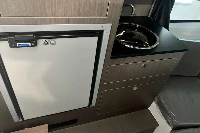 Slide: The Image of Compact kitchenette in the 2024 Beneteau Flyer 8 SUNdeck with fridge and sink. - 8