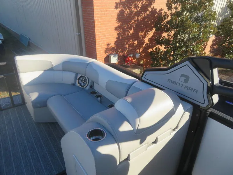Slide: The Image of 2023 Montara SURF BOSS MT2.0 25 boat interior with gray seating and cup holders. - 19