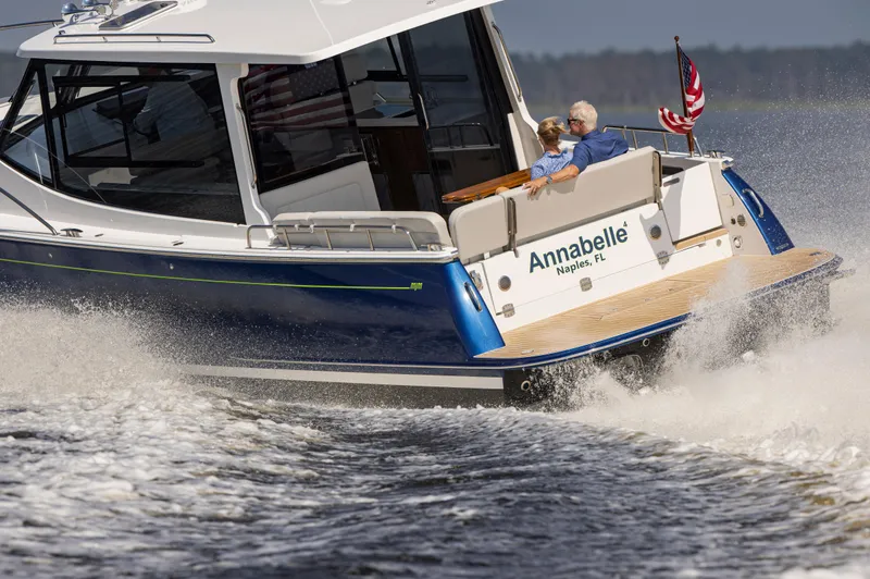 Slide: The Image of 2025 MJM 42 yacht "Annabelle" cruising on water, featuring sleek design and American flag. - 11