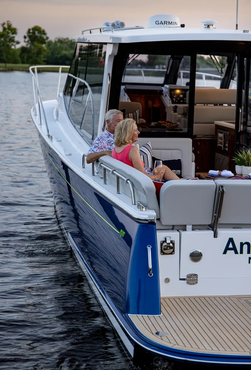 Slide: The Image of 2025 MJM 42 yacht cruising on calm waters with passengers relaxing. - 28