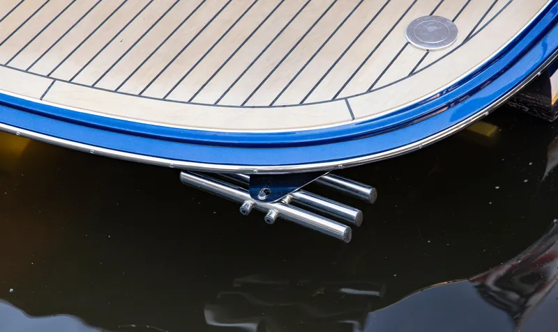 Slide: The Image of MJM 42 yacht stern detail, 2025 model, with sleek blue trim and wooden deck. - 29