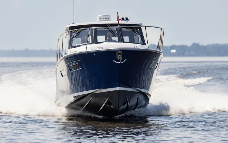 Slide: The Image of 2025 MJM 42 boat cruising on open water, front view. - 8