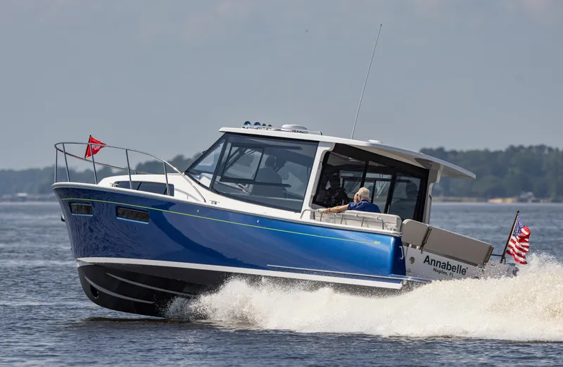 Slide: The Image of 2025 MJM 42 boat cruising on water, named Annabelle, with American flag. - 9