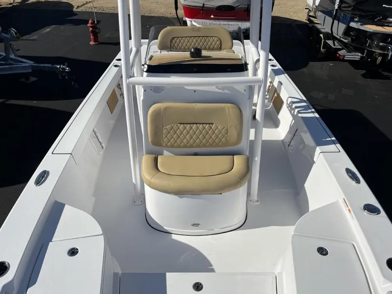Slide: The Image of 2023 Sportsman 227 MASTERS boat interior with beige cushioned seating and white deck. - 11