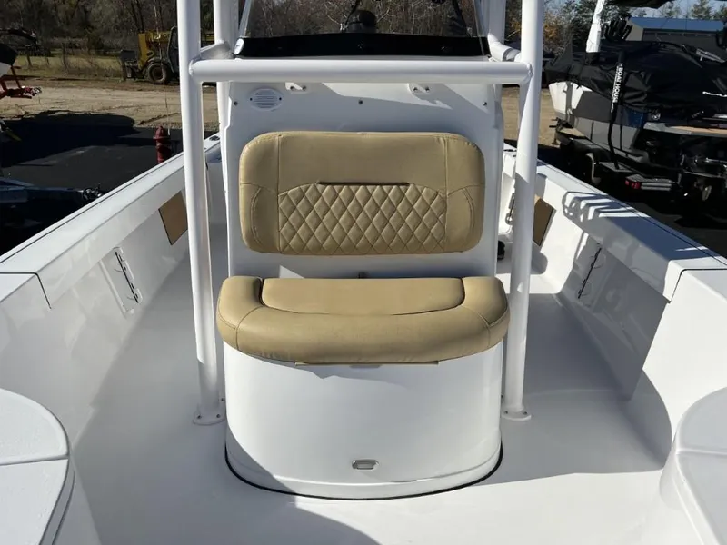 Slide: The Image of 2023 Sportsman 227 MASTERS boat with tan cushioned seating and white interior. - 12