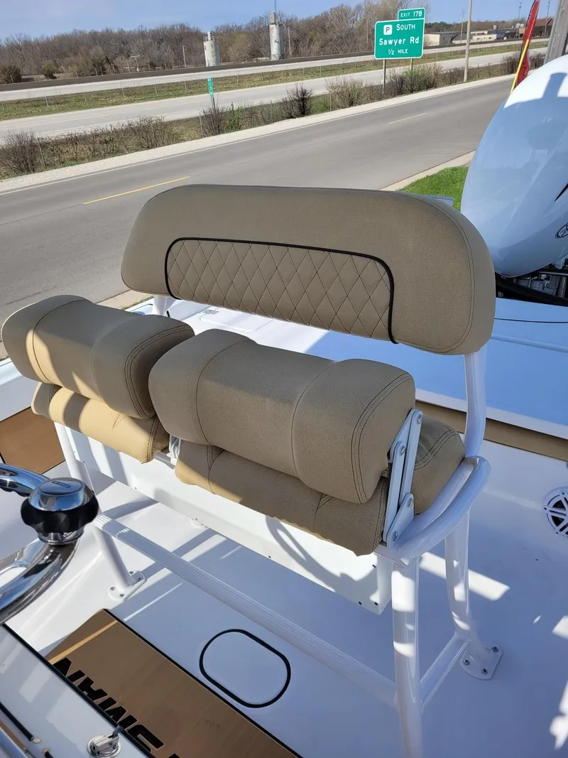 Slide: The Image of 2023 Sportsman 227 MASTERS boat with tan cushioned seating and steering wheel. - 13