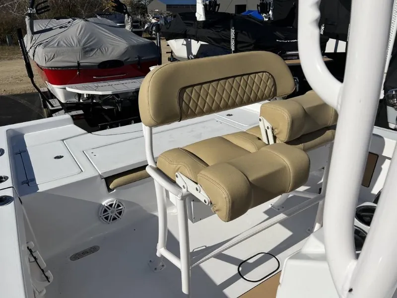Slide: The Image of 2023 Sportsman 227 MASTERS boat interior with beige cushioned seating. - 15