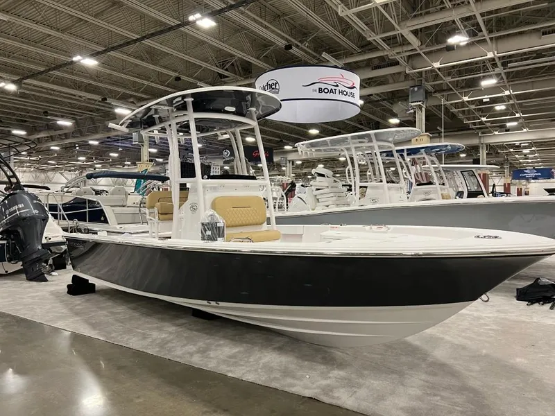 Slide: The Image of 2023 Sportsman 227 MASTERS boat displayed at an indoor boat show. - 20