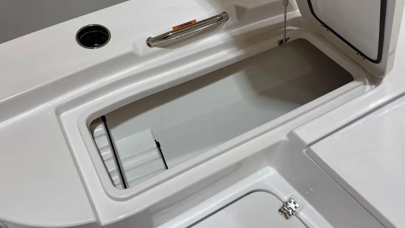 Slide: The Image of 2023 Sportsman 227 MASTERS boat storage compartment with open lid and handle. - 25