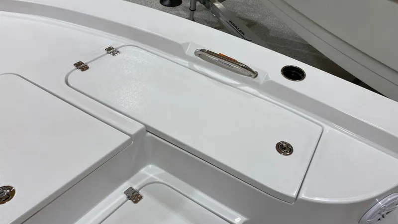 Slide: The Image of 2023 Sportsman 227 MASTERS boat deck with storage compartments and stainless steel handle. - 26