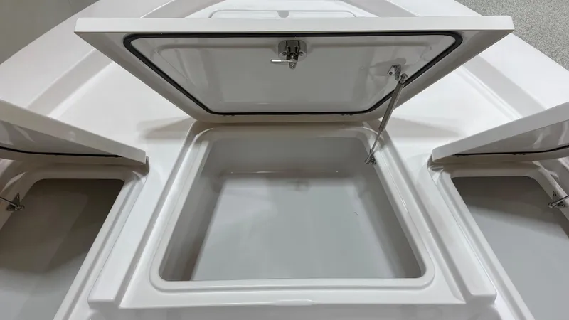 Slide: The Image of 2023 Sportsman 227 MASTERS boat storage compartments with open hatches. - 28