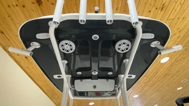 Slide: The Image of 2023 Sportsman 227 Masters boat T-top with rod holders and speakers. - 5