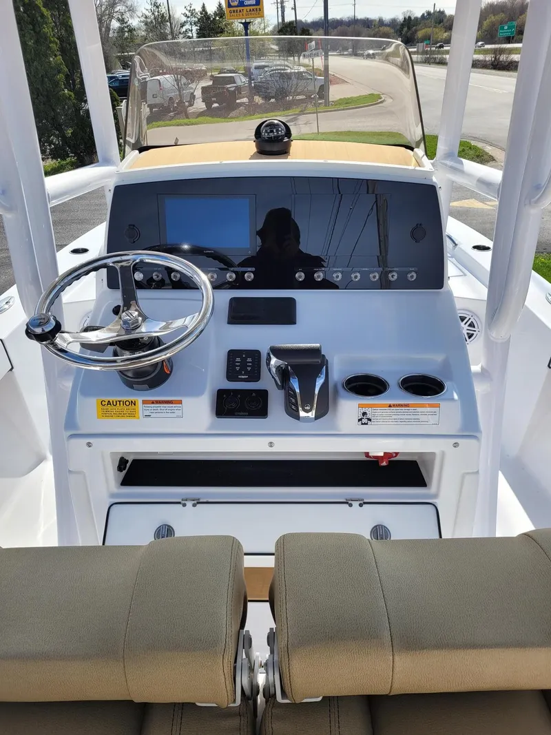Slide: The Image of 2023 Sportsman 227 MASTERS boat console with steering wheel, controls, and display. - 6