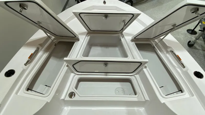 Slide: The Image of 2023 Sportsman 227 Masters boat with open storage compartments. - 9