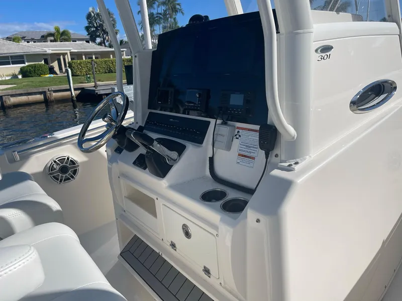 Slide: The Image of 2020 Cobia 301 Center Console with helm and seating. - 2