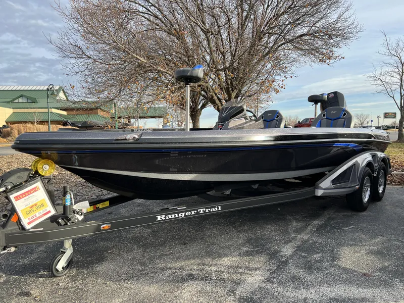Slide: The Image of 2023 Ranger Z520R bass boat on a Ranger Trail trailer in a parking lot. - 0