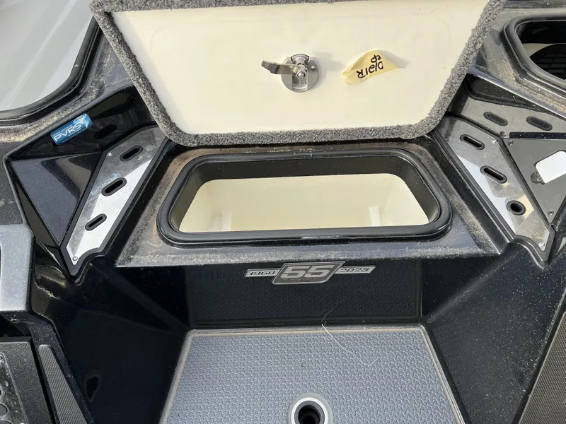 Slide: The Image of 2023 Ranger Z520R storage compartment with open lid and key. - 11
