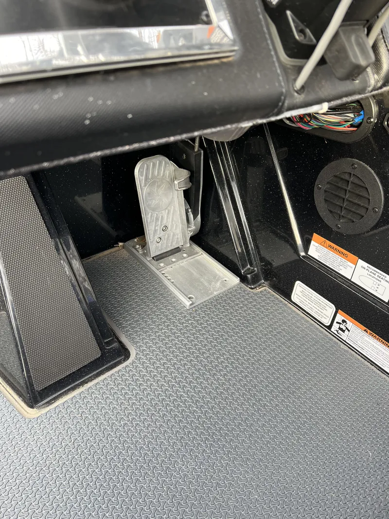 Slide: The Image of 2023 Ranger Z520R boat foot pedal and dashboard controls. - 14