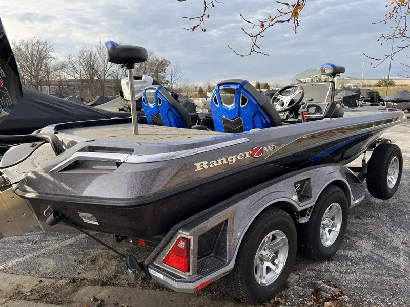 Slide: The Image of 2023 Ranger Z520R bass boat with dual axle trailer in a parking lot. - 3