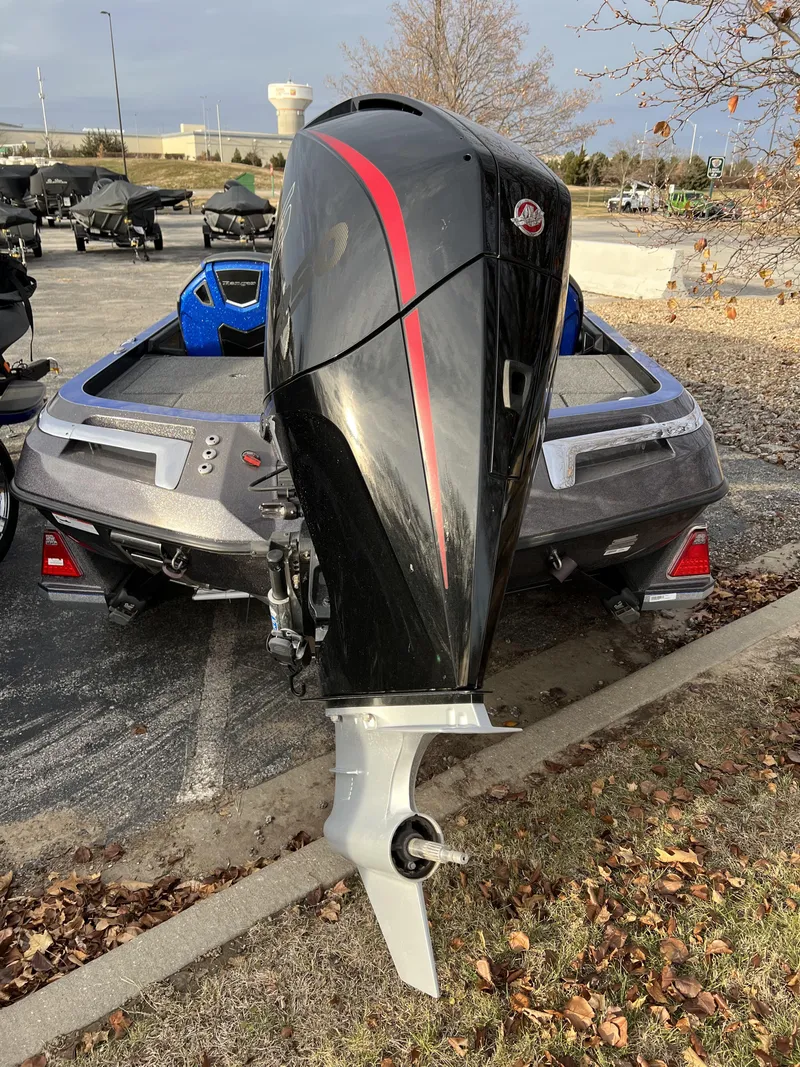 Slide: The Image of 2023 Ranger Z520R boat with a powerful outboard motor in a parking lot. - 4