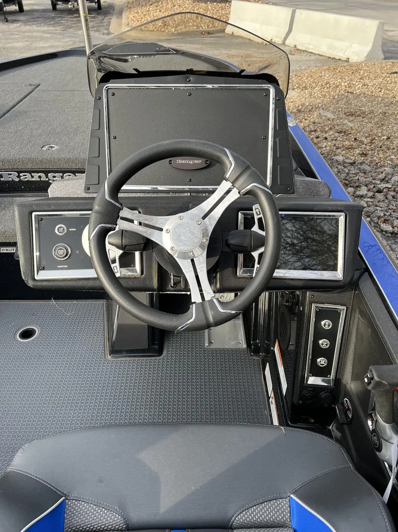 Slide: The Image of 2023 Ranger Z520R boat dashboard with steering wheel and control panel. - 6