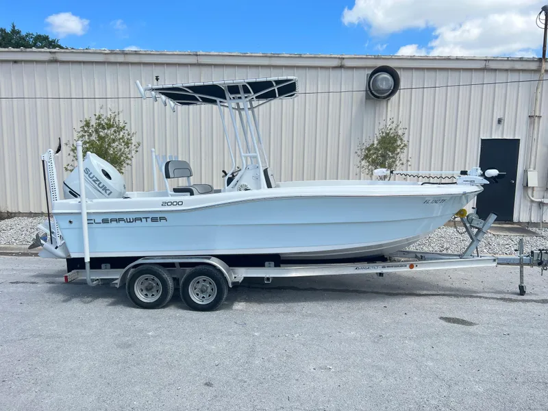 Slide: The Image of 2022 Clearwater 2000 boat on a trailer, parked outdoors. - 2