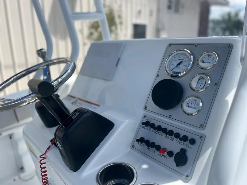 Slide: The Image of Clearwater 2000 boat dashboard with steering wheel and control panel, 2022 model. - 4