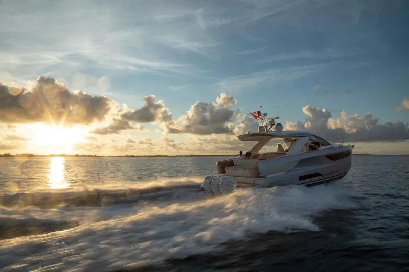 Slide: The Image of 2024 Jeanneau DB/43 OB yacht cruising at sunset on open water. - 3
