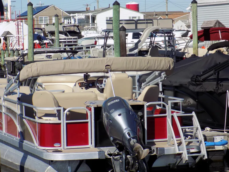 Slide: The Image of 2015 Bennington 24 SSX pontoon boat docked at a marina. - 6