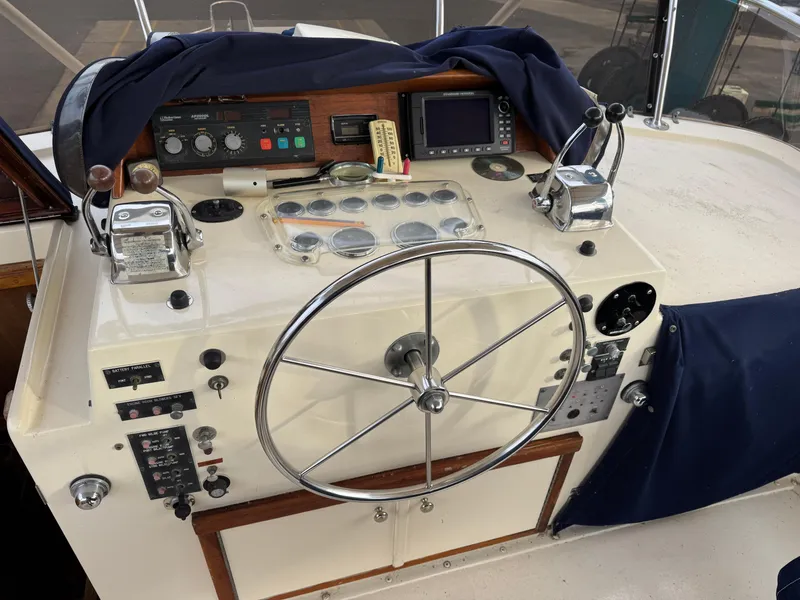 Slide: The Image of 1978 Hatteras 58 MY yacht helm with steering wheel and control panel. - 14
