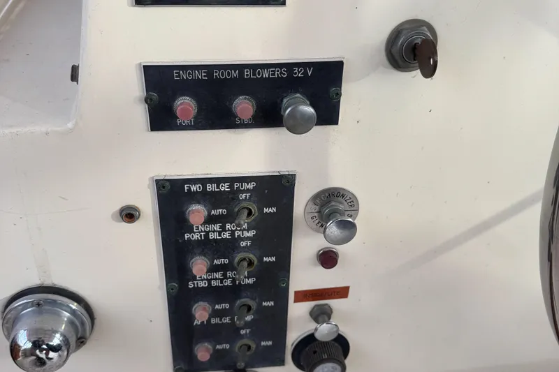 Slide: The Image of Control panel of a 1978 Hatteras 58 MY yacht, featuring engine room blowers and bilge pump switches. - 17
