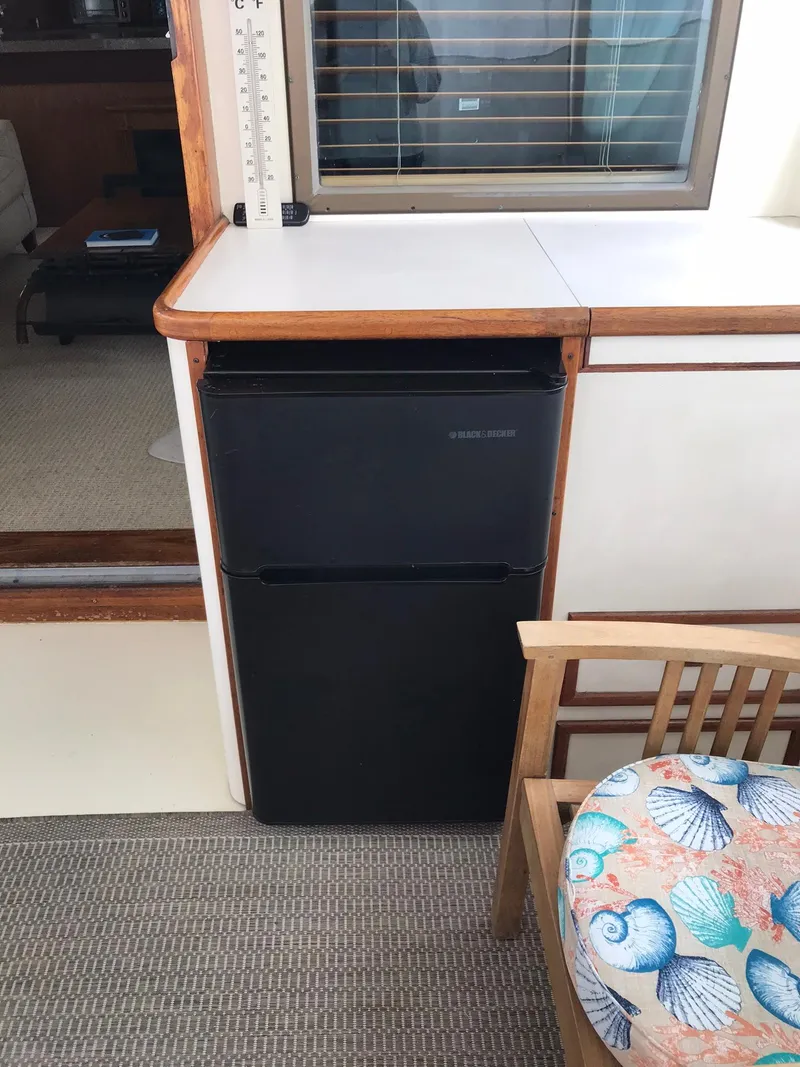 Slide: The Image of 1978 Hatteras 58 MY interior with mini fridge and seashell cushion. - 22