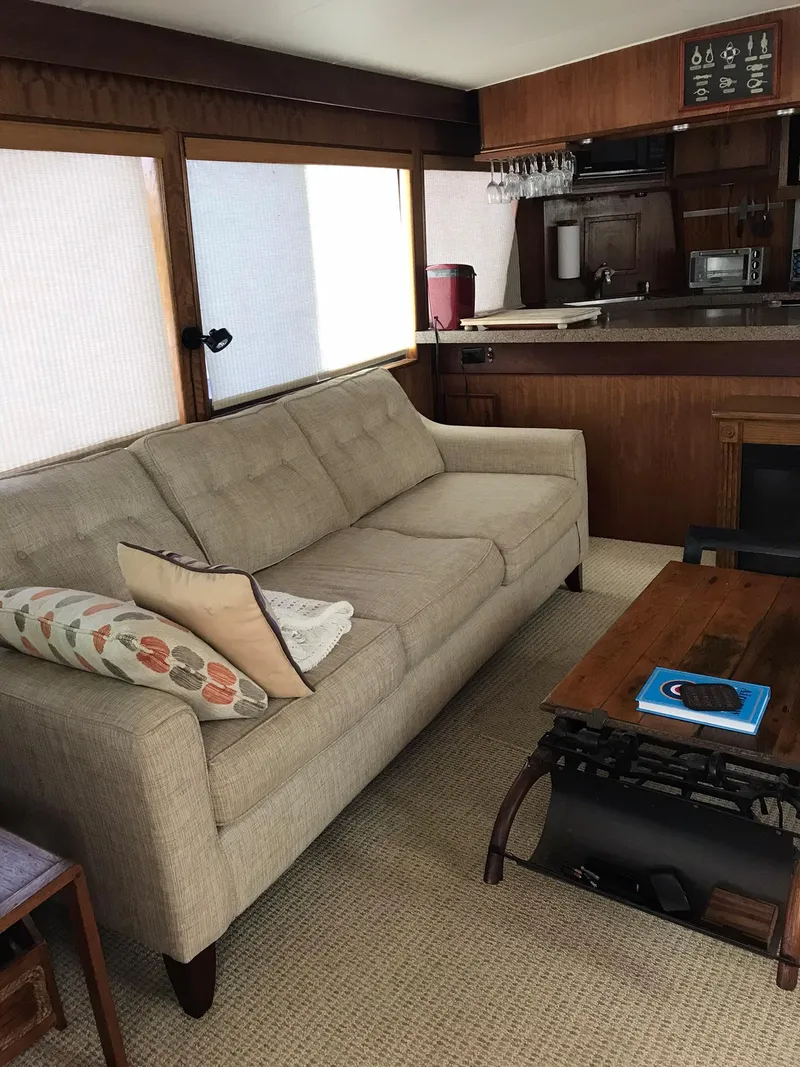 Slide: The Image of Interior of a 1978 Hatteras 58 MY yacht with a beige sofa and wooden accents. - 26