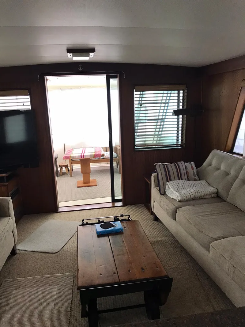 Slide: The Image of Interior of 1978 Hatteras 58 MY yacht with cozy seating and wooden table. - 28