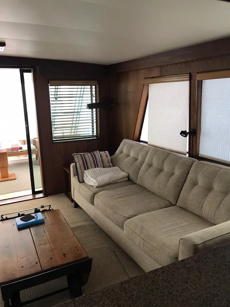 Slide: The Image of Interior of 1978 Hatteras 58 MY yacht with beige sofa and wooden table. - 30