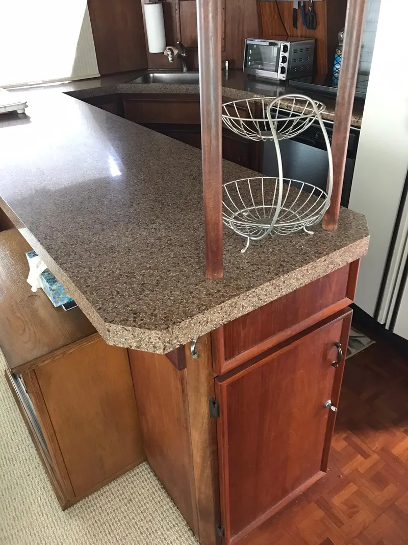 Slide: The Image of 1978 Hatteras 58 MY kitchen with granite countertop and wooden cabinets. - 31