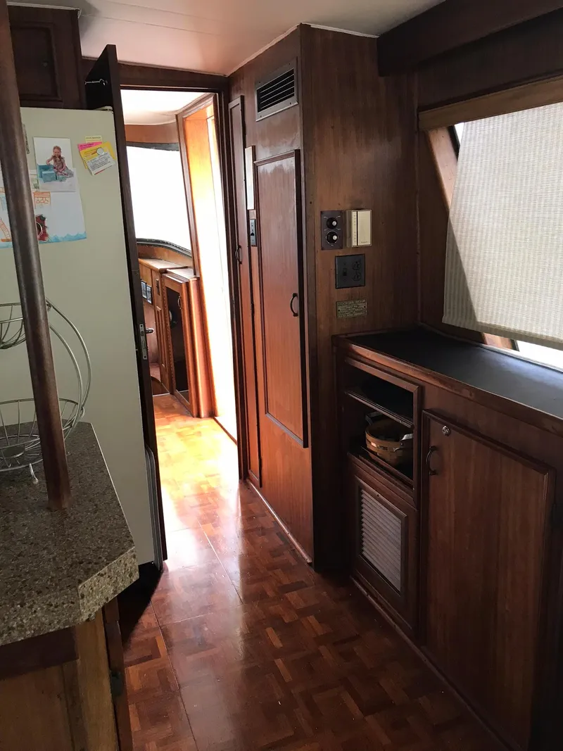 Slide: The Image of 1978 Hatteras 58 MY yacht interior with wooden cabinetry and parquet flooring. - 33