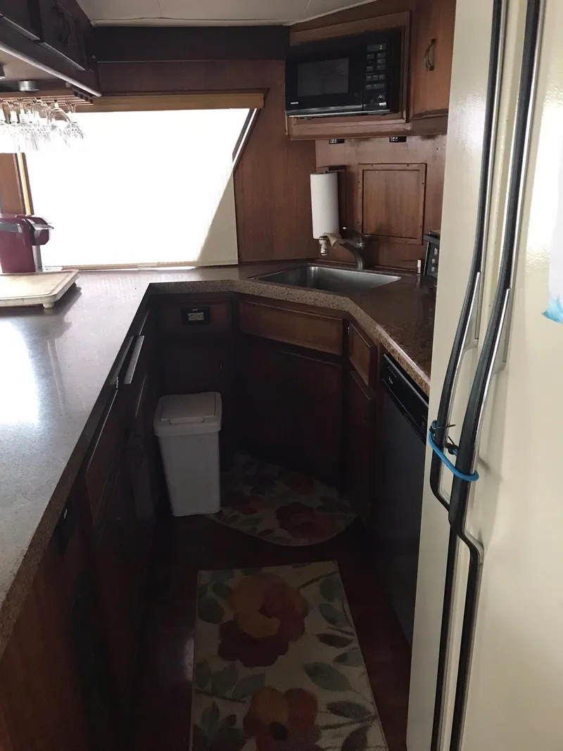Slide: The Image of 1978 Hatteras 58 MY yacht kitchen with wooden cabinets and modern appliances. - 34