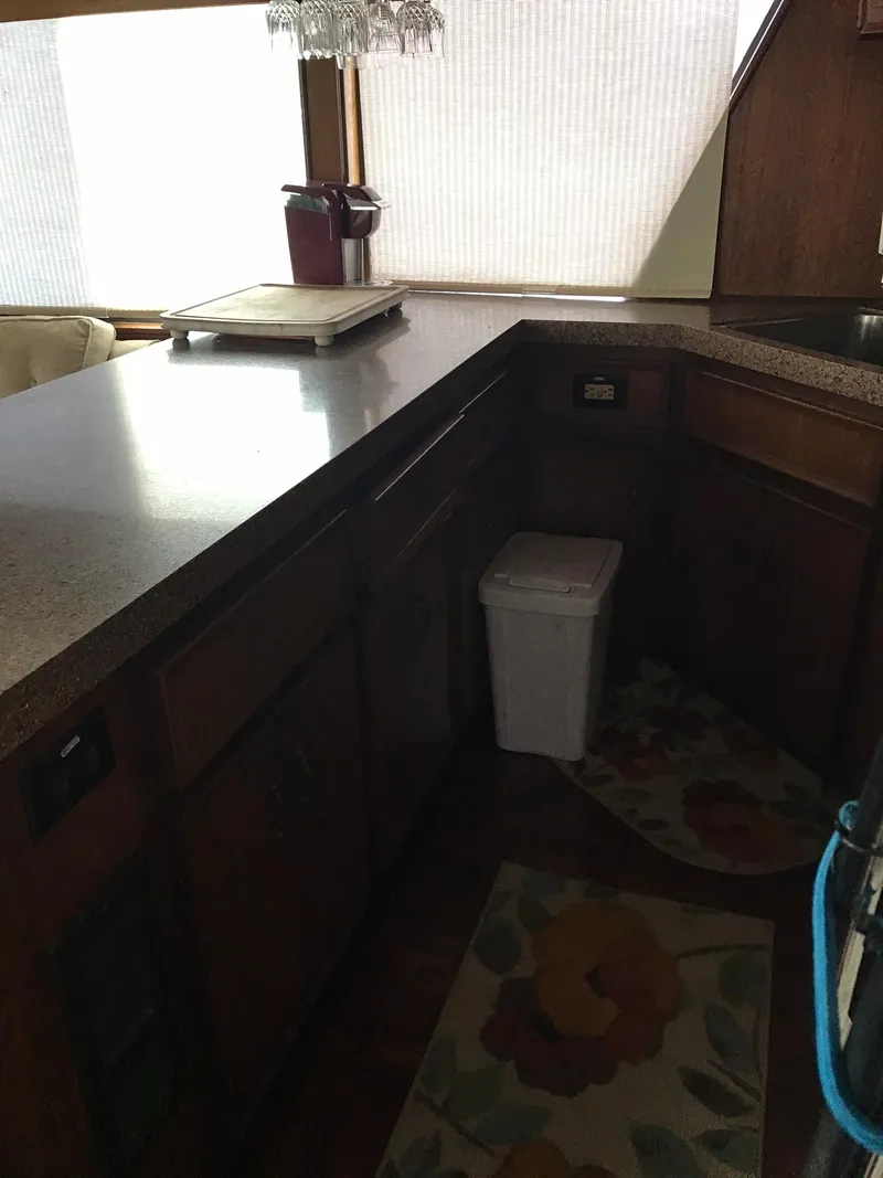 Slide: The Image of 1978 Hatteras 58 MY kitchen with wooden cabinets and countertops - 35