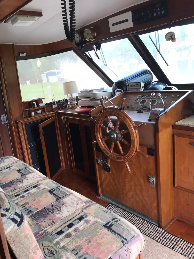 Slide: The Image of 1978 Hatteras 58 MY yacht interior helm with wooden steering wheel and control panel. - 39