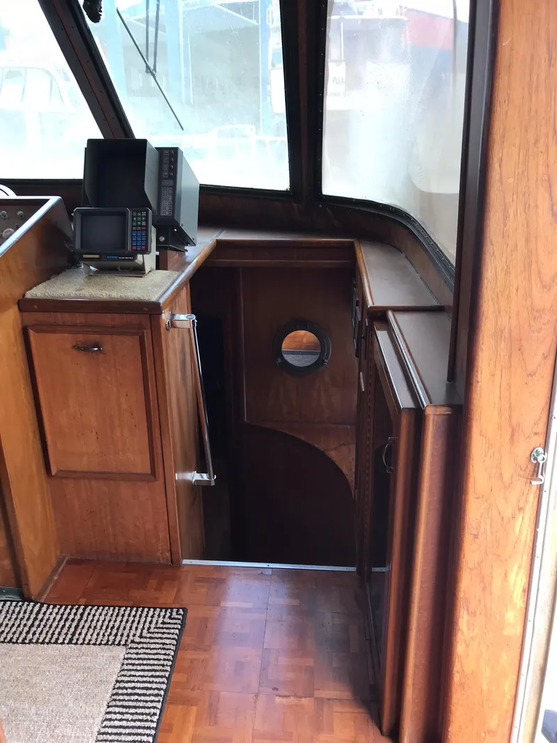 Slide: The Image of 1978 Hatteras 58 MY yacht interior with wooden cabinetry and navigation equipment. - 40