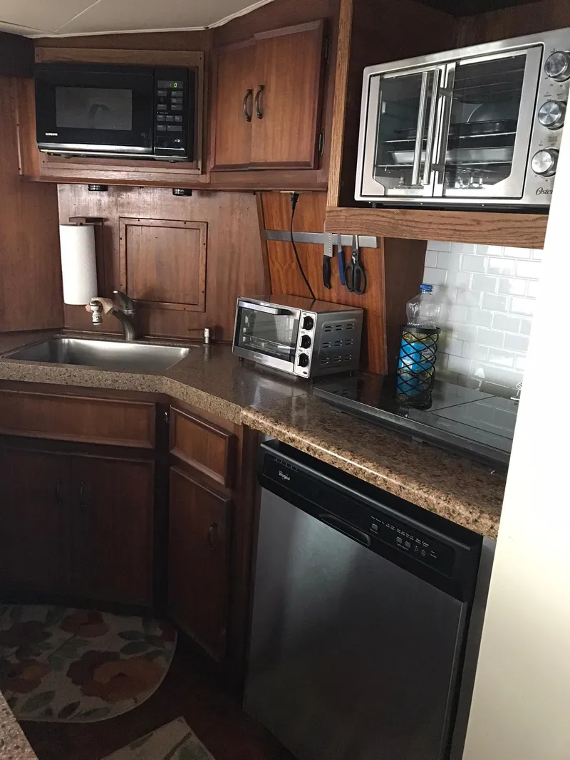 Slide: The Image of 1978 Hatteras 58 MY yacht kitchen with modern appliances and wooden cabinetry. - 41