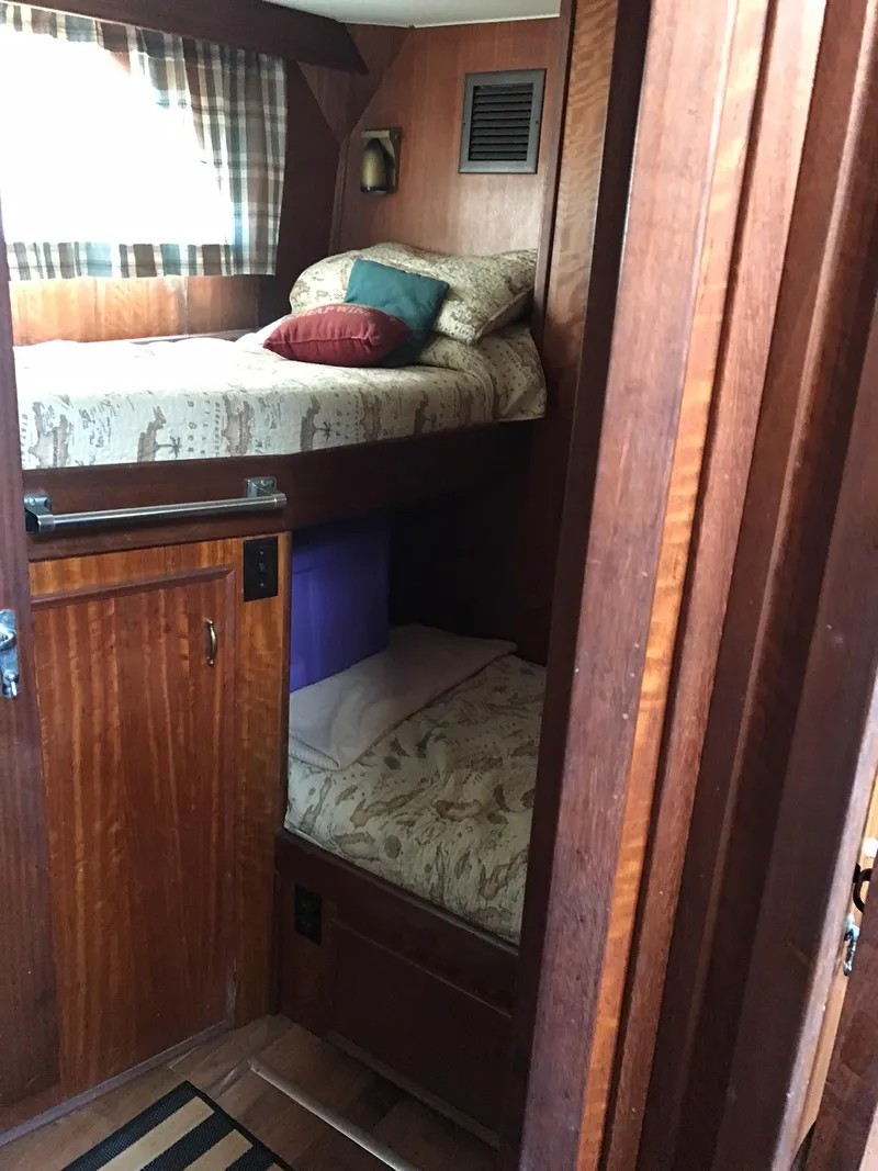 Slide: The Image of 1978 Hatteras 58 MY yacht interior with wooden bunk beds and cozy decor. - 51