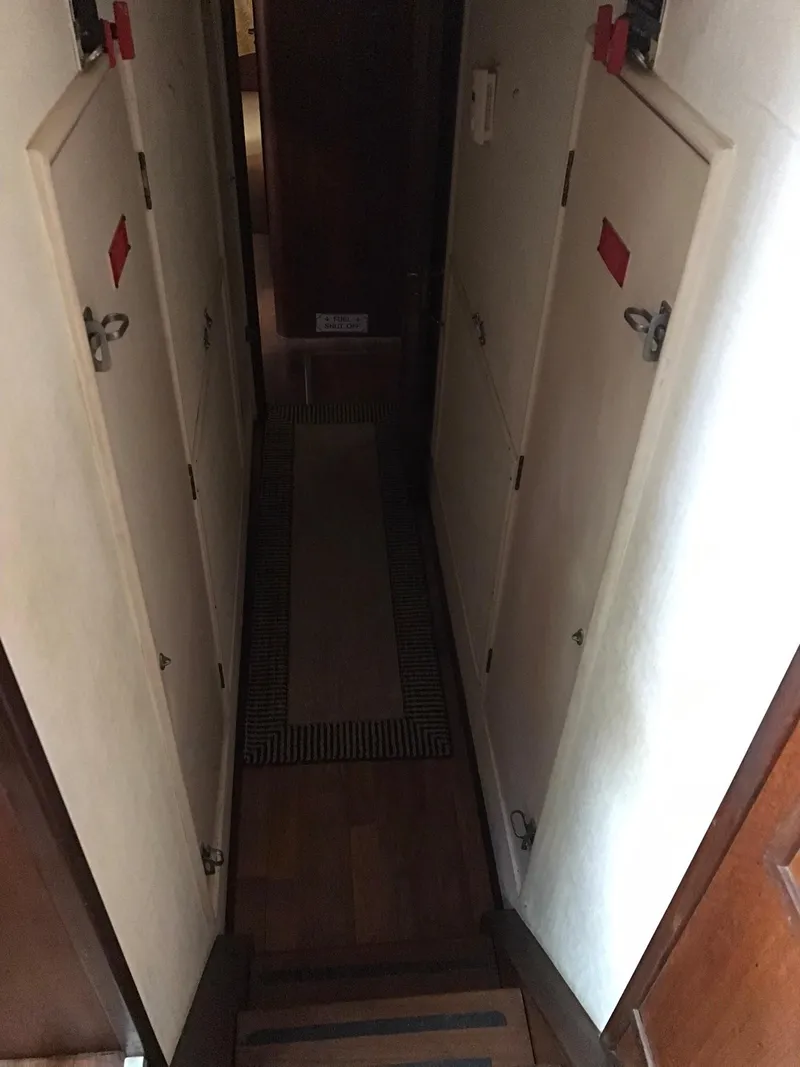 Slide: The Image of Narrow hallway inside a 1978 Hatteras 58 MY yacht with closed doors. - 54