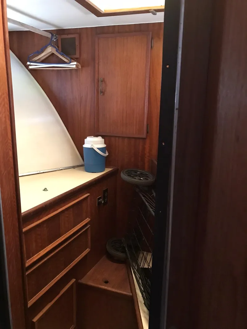 Slide: The Image of 1978 Hatteras 58 MY interior cabin with wooden cabinetry and storage space. - 58