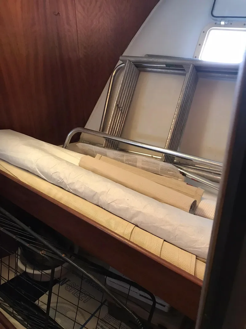 Slide: The Image of Interior of 1978 Hatteras 58 MY yacht with rolled-up materials and metal frames. - 59