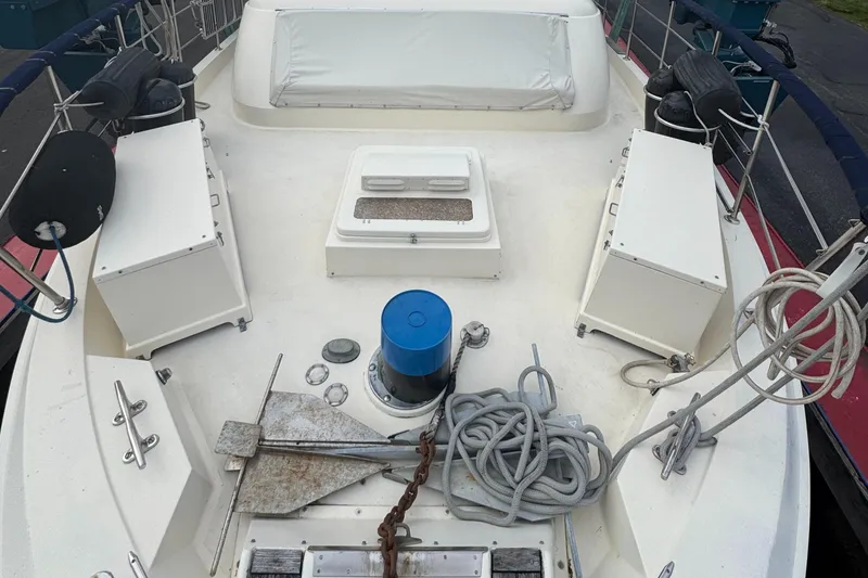 Slide: The Image of 1978 Hatteras 58 MY yacht deck with anchor, ropes, and storage compartments. - 6
