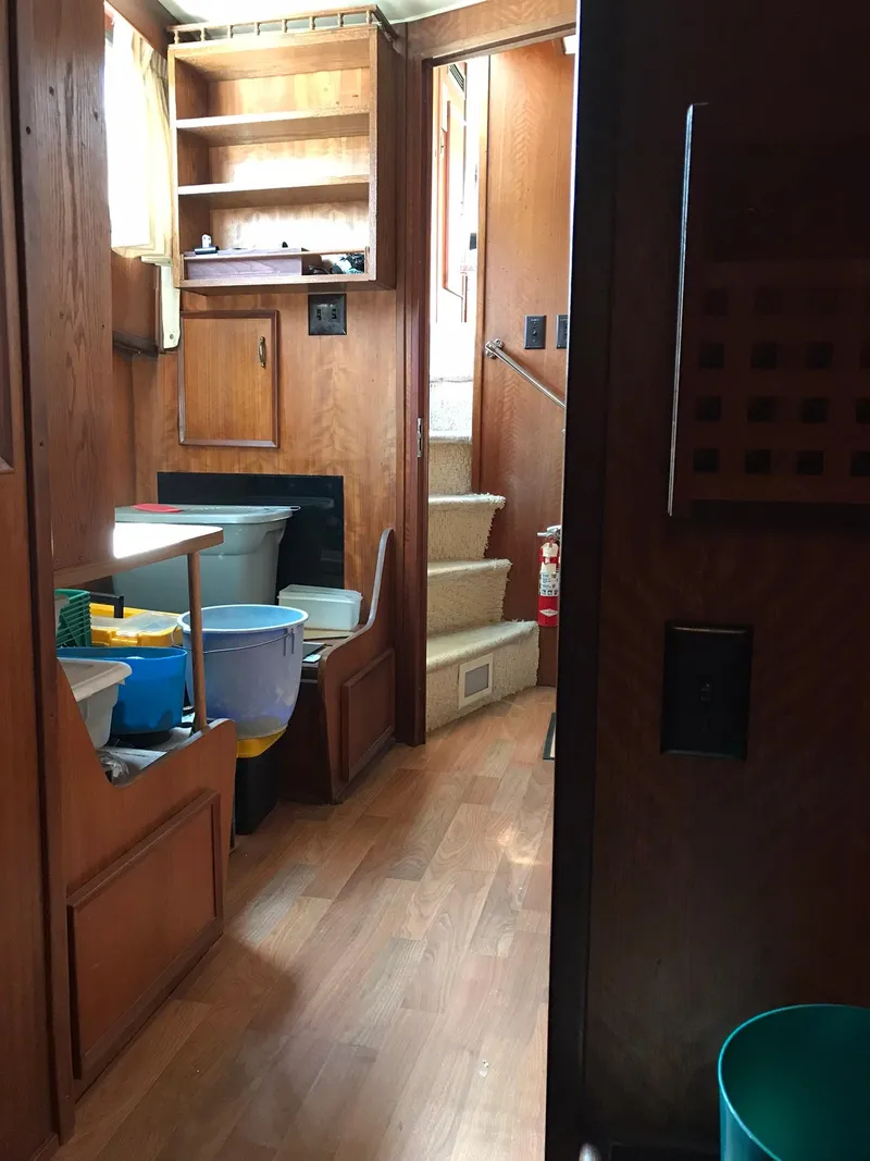Slide: The Image of Interior of a 1978 Hatteras 58 MY yacht with wooden cabinetry and stairs. - 63